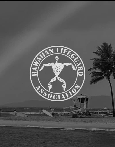 ANETIK x Hawaiian Lifeguard Association partnership logo over beach with lifeguard tower and palm trees