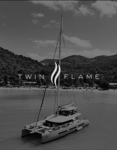 ANETIK x Twin Flame partnership logo over catamaran on tropical water